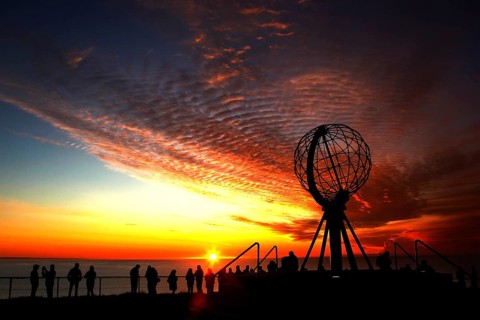 North Cape sunset with iconic globe and people in background, North Cape, Norway