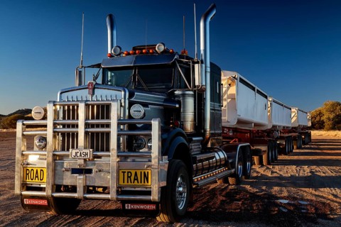 Large road train on Stuart Highway under clear skies, zero