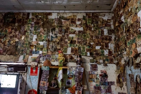 Historic interior of a hotel along the Stuart Highway, covered with notes and reminders, zero