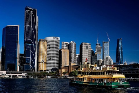 Sydney cityscape with passing ferry and skyscrapers in the background, Sydney, New South Wales,