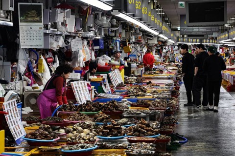 Bustling Jagalchi fish market in Busan full of people and stalls, Busan, South Korea