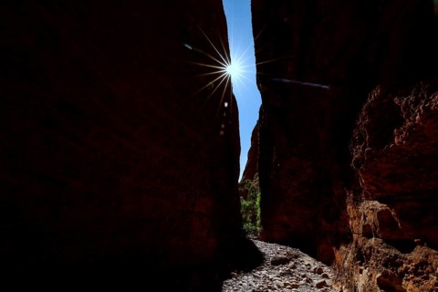 Light sweeps through the narrow Echidna Chasm and illuminates the rough rock walls, Purnululu,
