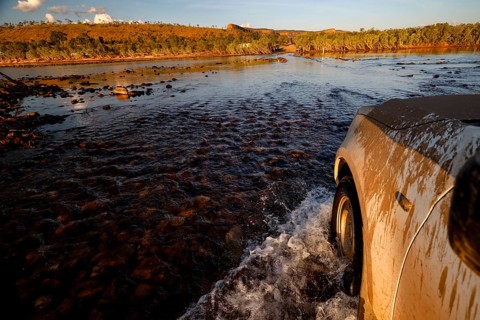A vehicle crosses the Pentecost River through a shallow ford when the sun is low, Pentecost River,