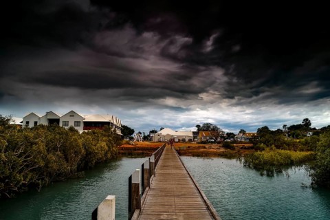 Streeters Jetty in Broome with dramatic clouds over coastal landscape, Broome, Western Australia,