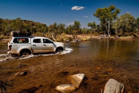 Vehicle crosses shallow river in remote area of Purnululu National Park, Purnululu National Park,