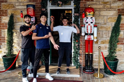 Three people standing smiling in front of a gift shop in Hahndorf, Hahndorf, South Australia,