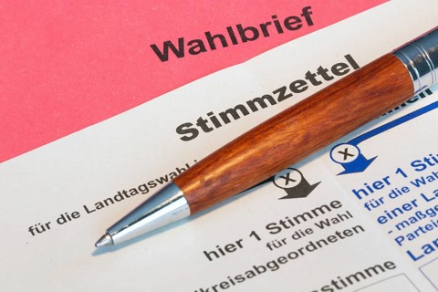 Absentee voting symbol: Close-up of a ballot letter with a ballot paper attached
