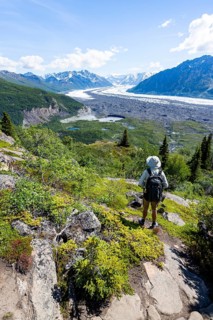 Young man enjoying the view, view of impressive mountain landscape with Matanuska glacier and