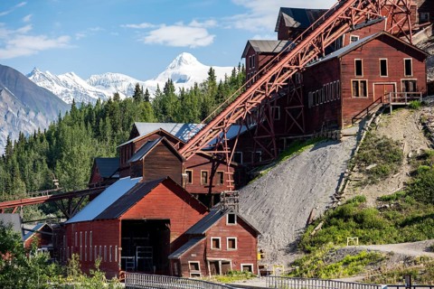Red Kennicott buildings in front of mountainous landscape, Kennicott Concentration Mill to extract