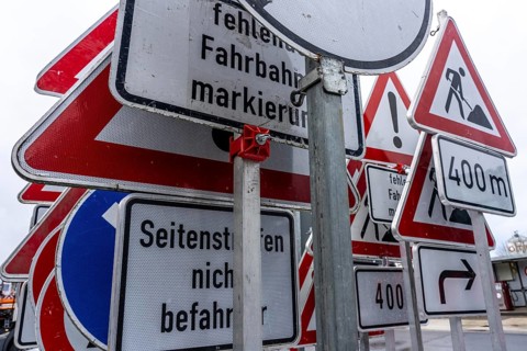 Storage for traffic signs in the yard of a road maintenance department, various signs with