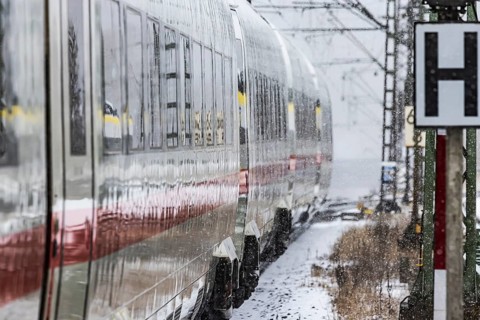 ICE traveling through a winter landscape in snowfall. A train on the line in the Deutsche Bahn