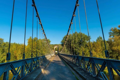 Suspension bridge of Coudes village on river Allier. Puy de Dome. Auvergne Rhone Alpes. France