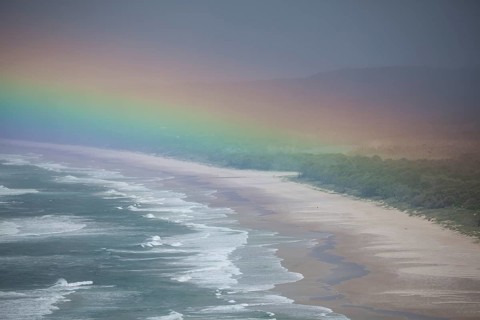 Tallow Beach bay with rainbow, lookout Byron Bay lighthouse, New South Wales, Australia