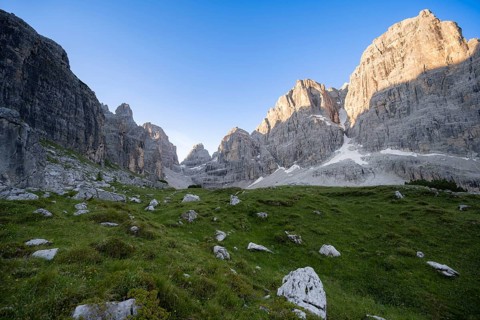 Picturesque mountain landscape in Val Brenta Alta at sunrise, rocky peaks of Cima Tosa,