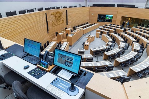 Plenary hall deserted with the seats of deputies and the government bank. Behind it is the