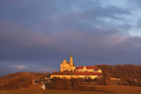 Benedictine monastery with late baroque monastery church, lighting atmosphere, winter, Neresheim,