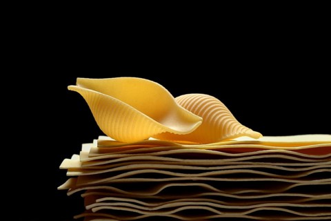 Uncooked lasagna leaves and mussel noodles, conchiglione