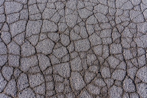 Asphalt surface, floor, with many small cracks, roadway, parking lot