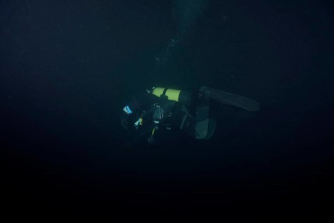 Divers at night in Lake Walen. Tauchplatz Känzeli, Mols, Canton of St. Gallen, Switzerland