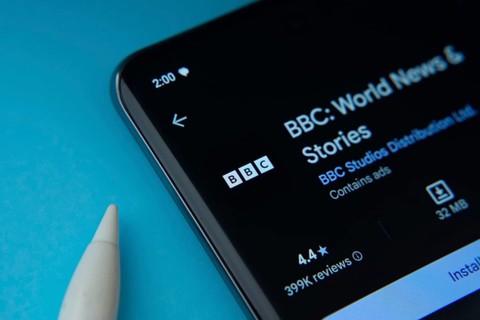 Dhaka, Bangladesh- 29 May 2025: On a blue surface, a smartphone displays the BBC app within the