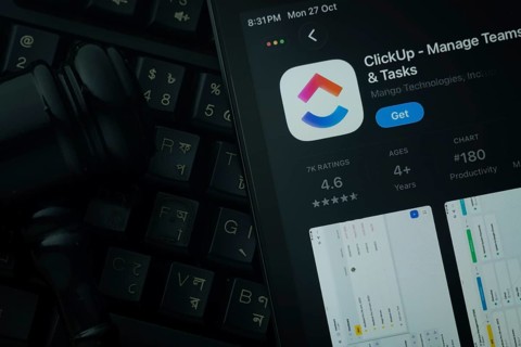 Dhaka, Bangladesh- 28 Oct 2025: An iPad displaying the ClickUp app against a judge's gavel and dark