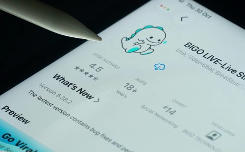 Dhaka, Bangladesh- 30 Oct 2025: Bigo Live app on a iPad screen with a pen pointing at the install