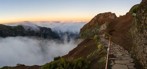 Sunrise at Pico do Arieiro, clouds of fog sweep over mountain peaks, sea of fog, hiking trail PR1,