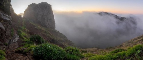 Sunrise at Pico do Arieiro, clouds of fog pass over mountain peaks, hiking trail PR1, Madeira,