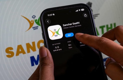 In this photo illustration, a person downloads the Sanchar Saathi mobile application on an iPhone,