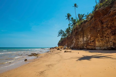 Lonely beach with red rocks and coconut trees, Red Cliffs, Bang Saphan Noi, Prachuap Khiri Khan