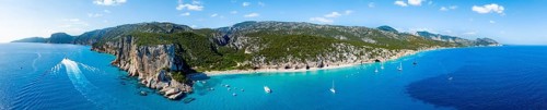 Picturesque rocky coast, cliffs and Cala Luna beach, aerial view, Golfo di Orosei, Baunei,