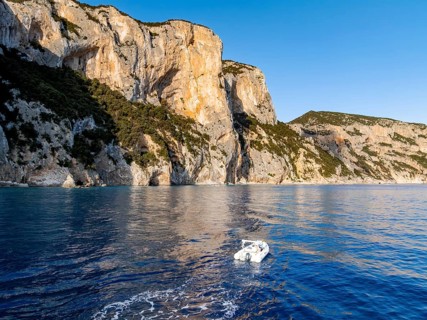 Motorboat rides on picturesque rocky coast ImmorgenLicht, cliffs, Golfo di Orosei, Baunei,