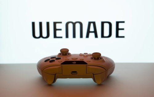 Dhaka, Bangladesh- 14 Nov 2025: A close-up of a white gamepad with the WeMade Entertainment seen on