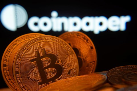 Dhaka, Bangladesh- 19 Sep 2025: Close-up of Bitcoin coins with the Coinpaper logo visible on a