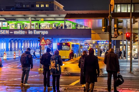 The main train station in Essen, blue illuminated underpass, bus station, am Europaplatz, train on