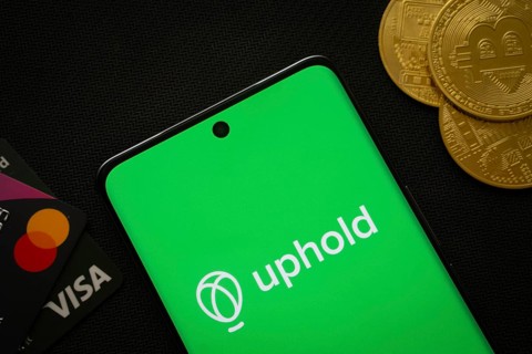 Dhaka, Bangladesh- 03 Sep 2025: Smartphone displaying Uphold logo surrounded by Bitcoin coins and