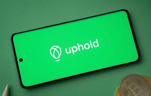 Dhaka, Bangladesh- 19 Sep 2025: Uphold logo on smartphone screen near Bitcoin coin and QR code on