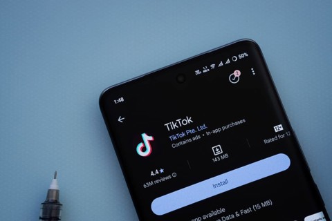 Dhaka, Bangladesh- 29 May 2025: On a blue surface, a smartphone displays the TikTok app within the