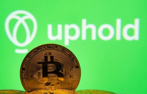Dhaka, Bangladesh- 19 Sep 2025: Close-up of Bitcoin coins with the Uphold logo visible on a screen