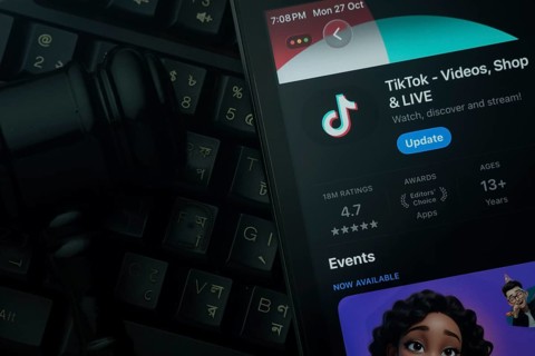 Dhaka, Bangladesh- 28 Oct 2025: An iPad displaying the TikTok app against a judge's gavel and dark