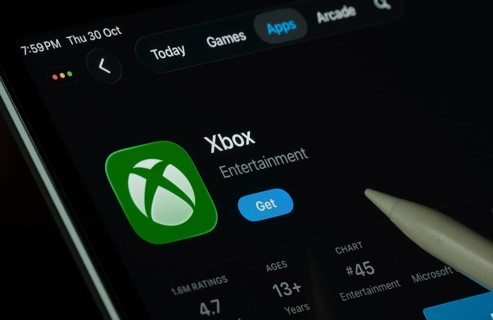 Dhaka, Bangladesh- 30 Oct 2025: Xbox app displayed on a iPad screen in dark mode with a digital pen