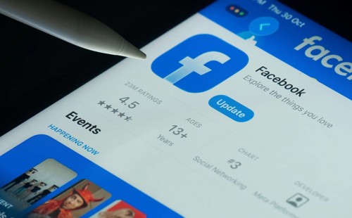 Dhaka, Bangladesh- 30 Oct 2025: Facebook app on a iPad screen with a pen pointing at the install