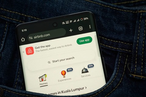 Dhaka, Bangladesh- 21 Nov 2025: A smartphone displaying the Airbnb web interface peeks out of a