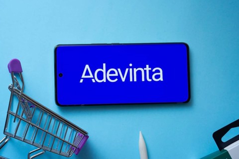 Dhaka, Bangladesh- 03 July 2025: Smartphone displaying Adevinta logo with shopping cart on a blue