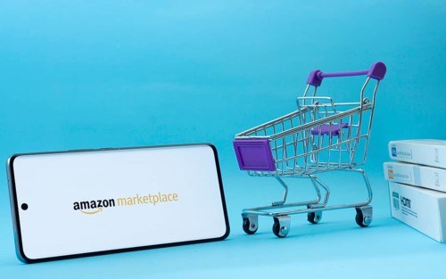 Dhaka, Bangladesh- 21 Nov 2025: Smartphone with amazon marketplace logo next to a small shopping
