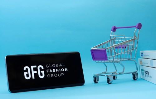 Dhaka, Bangladesh- 21 Nov 2025: Smartphone with Global Fashion Group logo next to a small shopping