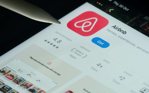 Dhaka, Bangladesh- 21 Nov 2025: Airbnb app on a iPad screen with a pen pointing at the install