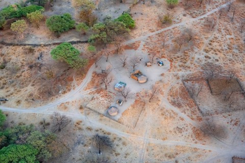 Settlement, simple house and fence, dry savanna landscape, near Maun, aerial view, Okavango Delta,