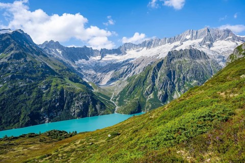 Turquoise blue mountain lake Göscheneralpsee, picturesque mountain landscape with dammastock and