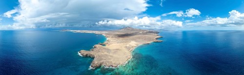 Headland and blue sea, coastal landscape, arid landscape of Los Ajaches Natural Park, aerial view,